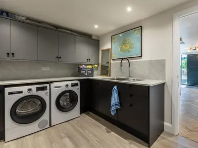 a kitchen with a washing machine and a sink at 5 Bed in Fowey oc-93849 in Polruan