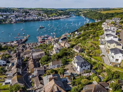 an aerial view of a town with boats in the water at 5 Bed in Fowey oc-93849 in Polruan