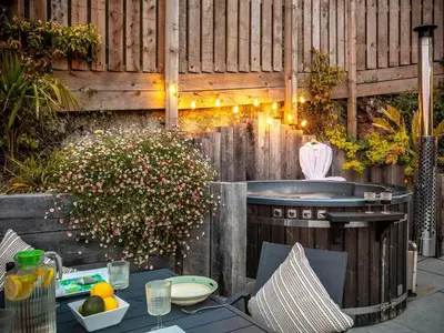 a backyard patio with a grill and a table and chairs at 5 Bed in Fowey oc-93849 in Polruan