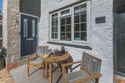 a patio with a table and chairs and a window at 3 Bed in Sithney oc-cpv110 in Carleen