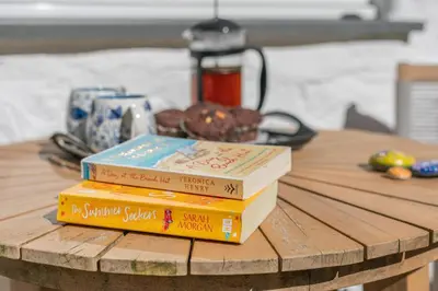 a stack of books sitting on top of a table at 3 Bed in Sithney oc-cpv110 in Carleen