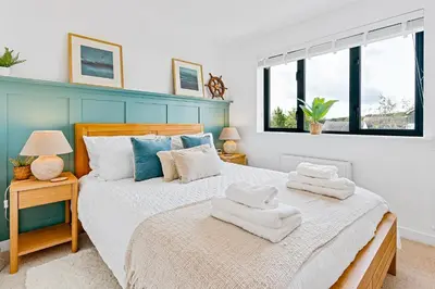 a bedroom with a bed with towels on it at Offshore, Coastal retreat, set in the heart of Charlestown in Charlestown