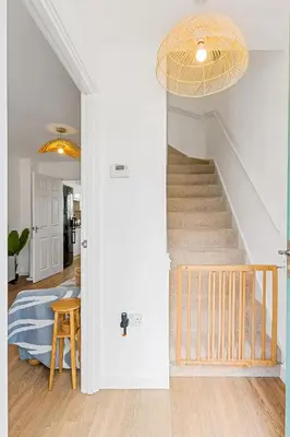 a hallway with a staircase in a home with a ceiling at Offshore, Coastal retreat, set in the heart of Charlestown in Charlestown