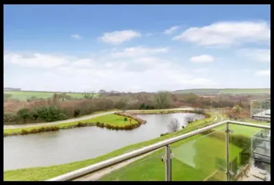 a view of a river from a balcony at Tallyn House 202 in Saint Columb Major