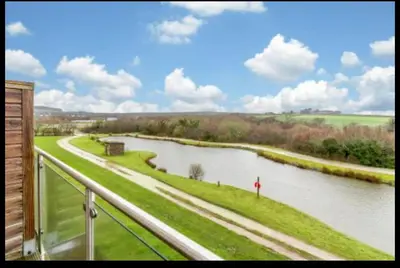 a view of a river from a balcony at Tallyn House 202 in Saint Columb Major