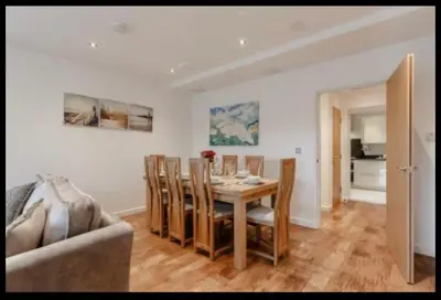 a dining room with a table and chairs at Tallyn House 202 in Saint Columb Major