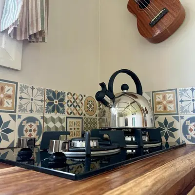 a kitchen with a stove top with a pot on it at Harpers Huts in Lanivet