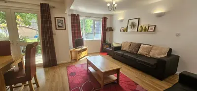 a living room with a couch and a table at Family and dog-friendly holiday home - 134 Hengar Manor in Saint Tudy