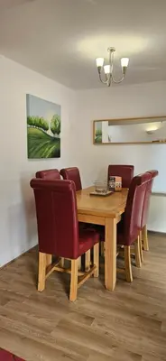 a dining room with a wooden table and chairs at Family and dog-friendly holiday home - 134 Hengar Manor in Saint Tudy