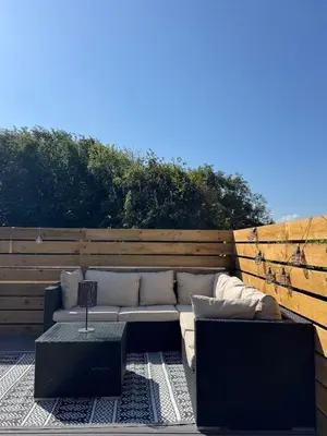 a couch and a coffee table on a patio at The Beach Hut in Perranporth