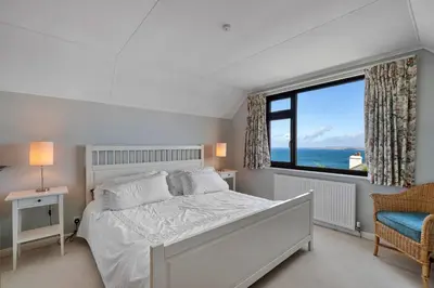 a bedroom with a bed and a large window at Finest Retreats - Michel in Carbis Bay