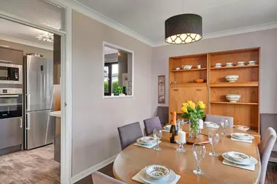 a kitchen and dining room with a wooden table and chairs at Finest Retreats - Michel in Carbis Bay
