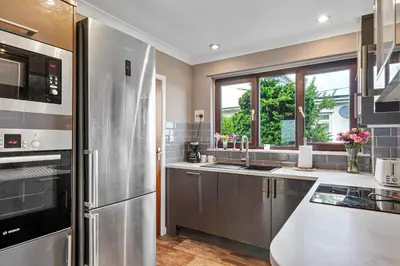 a kitchen with stainless steel appliances and a window at Finest Retreats - Michel in Carbis Bay