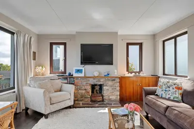 a living room with a fireplace and a tv at Finest Retreats - Michel in Carbis Bay