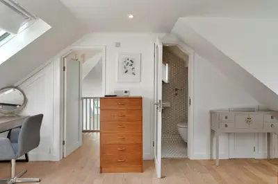 a bedroom with a desk and a dresser in a attic at Finest Retreats - Three Quarter Cottage in Bodinnick