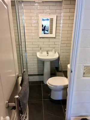 a small bathroom with a toilet and a sink at Coach House Studio, quiet, rural, pet friendly, Probus in Probus