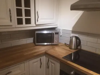 a kitchen with a microwave on a wooden counter top at Coach House Studio, quiet, rural, pet friendly, Probus in Probus