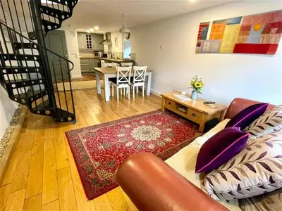 a living room with a couch and a table at Coach House Studio, quiet, rural, pet friendly, Probus in Probus