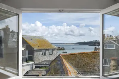 a window view of the ocean from a house at Cosy Fisherman's Cottage Seconds from Waterfront in St Ives