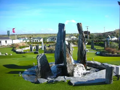 a sculpture of rocks on a golf course at Chalet 150, Perran Sands in Perranporth