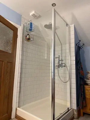 a shower stall in a bathroom with a tub at Buddleia Cottage Trewoon, St Austell in St Austell