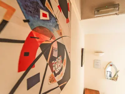a room with a painting of a woman on the wall at Holiday Home Tregony House 1 Bedroom by Interhome in Mevagissey