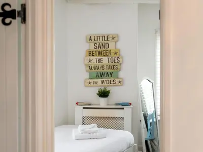 a room with a bed and a mirror at Holiday Home Mermaid Cottage by Interhome in Mevagissey