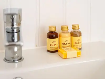 three bottles of honey sitting on a sink at Holiday Home Mermaid Cottage by Interhome in Mevagissey