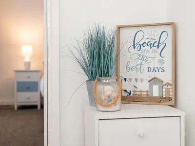 a picture on a dresser with a vase on it at Holiday Home Mermaid Cottage by Interhome in Mevagissey