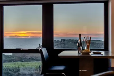 a table with a view of the ocean from a window at 2 Bed in Tintagel oc-g33170 in Tintagel