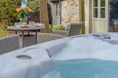 a table and chairs on a patio with a table and a table at 1 Bed in Newquay oc-c33290 in Saint Columb Major