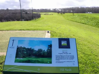 a sign in a field with a golf course at Lodge 83, Gwel an Mor in Redruth