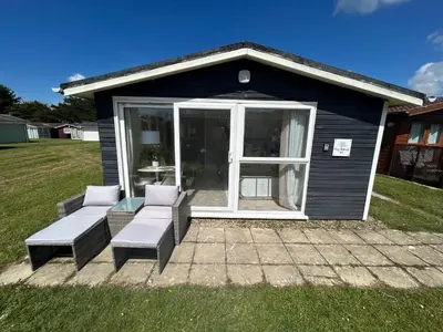 a small house with two couches and a patio at Cozy Retreat in Padstow