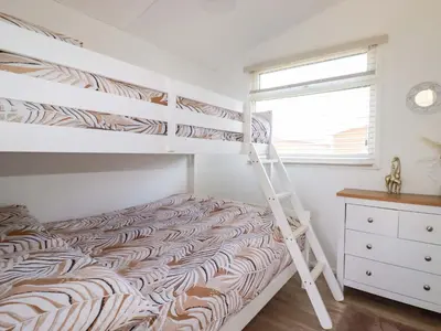 a bedroom with two bunk beds and a ladder at Cozy Retreat in Padstow