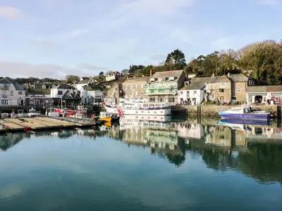 a river with boats docked in a small town at Cozy Retreat in Padstow