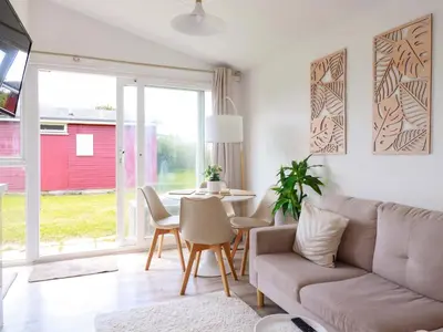 a living room with a couch and a table at Cozy Retreat in Padstow