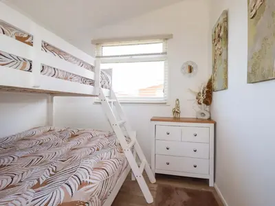 a bedroom with a bunk bed and a ladder at Cozy Retreat in Padstow
