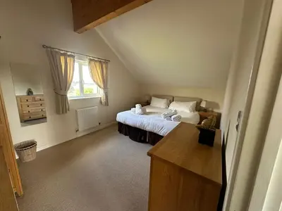 a bedroom with a bed and a window at Redwood at Retallack Resort in Saint Columb Major