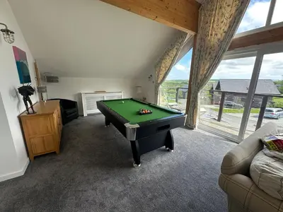 a living room with a pool table in a room at Redwood at Retallack Resort in Saint Columb Major