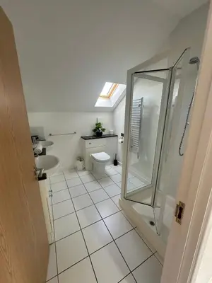 a bathroom with a shower and a toilet and a sink at Redwood at Retallack Resort in Saint Columb Major