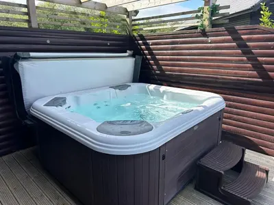 a jacuzzi tub sitting on a patio at Redwood at Retallack Resort in Saint Columb Major