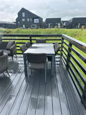 a table and chairs sitting on a wooden deck at Barn 21 at Retallack Resort in Saint Columb Major