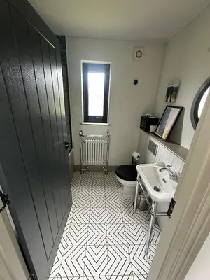 a bathroom with a toilet and a sink at Barn 21 at Retallack Resort in Saint Columb Major