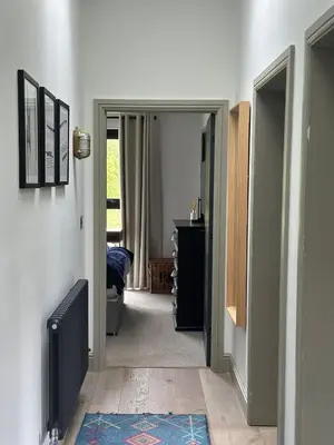 a hallway with an open door to a room at Barn 21 at Retallack Resort in Saint Columb Major