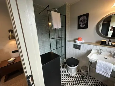 a bathroom with a toilet and a sink at Barn 21 at Retallack Resort in Saint Columb Major