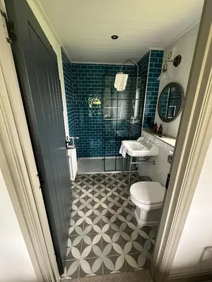 a bathroom with a tub and a toilet and a sink at Barn 21 at Retallack Resort in Saint Columb Major