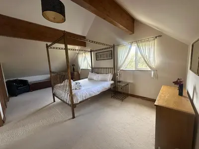 a bedroom with a canopy bed and a window at Willow at Retallack Resort in Saint Columb Major