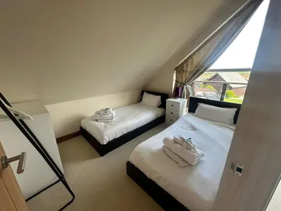 a bedroom with two beds with towels on them at Willow at Retallack Resort in Saint Columb Major