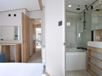 a bathroom with a shower and a bed and a tub at Eden Way 47 in Par