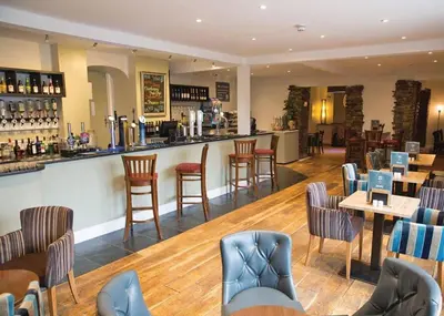 a bar in a restaurant with chairs and tables at Atlantic Lodge - 4 Bedroom - Pool -Spa - Gym in Newquay